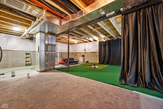 game room featuring heating unit and carpet