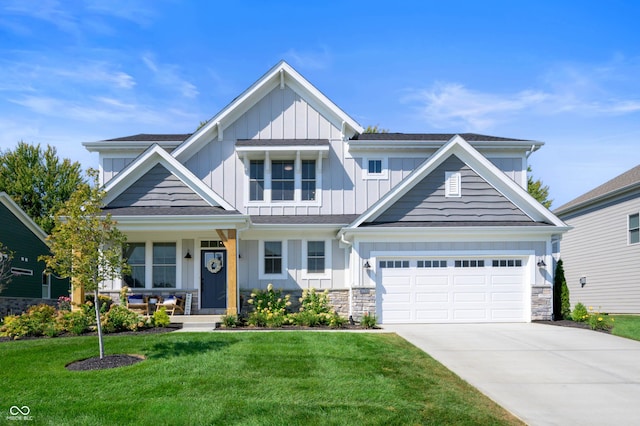 craftsman house with a garage, covered porch, and a front lawn