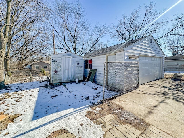 snow covered structure with a garage