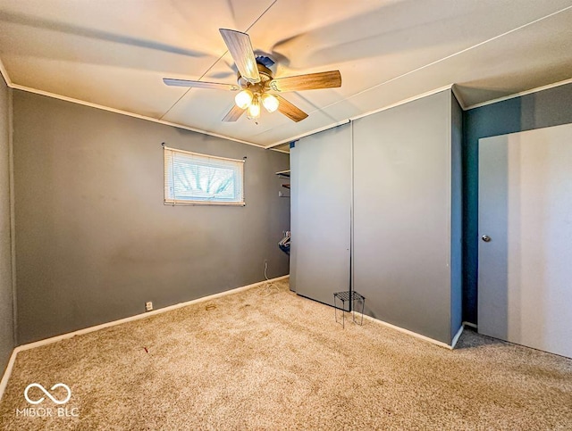 interior space with crown molding and ceiling fan