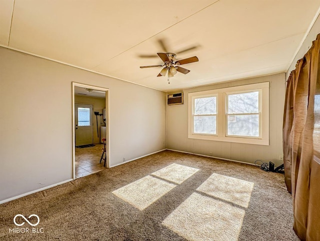 carpeted spare room featuring a wall mounted air conditioner and ceiling fan