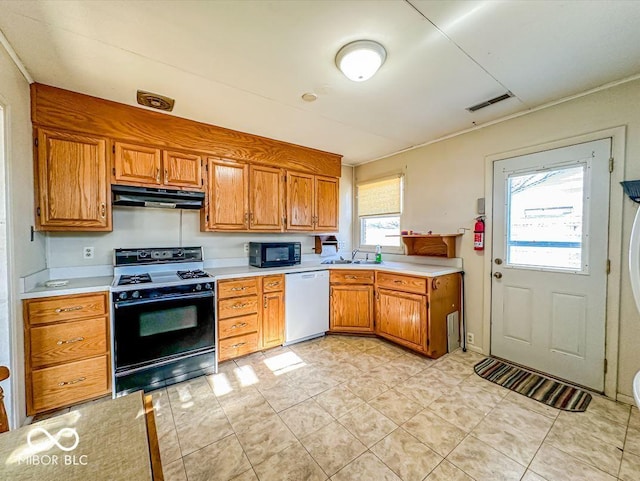 kitchen featuring sink, white dishwasher, and gas range oven