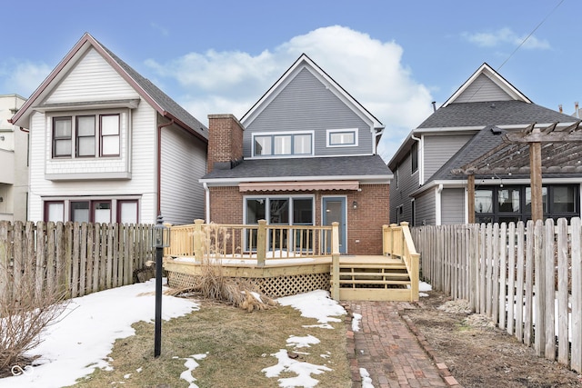 rear view of house featuring a deck