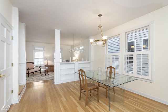 dining room with a notable chandelier and light wood-type flooring