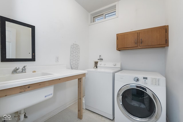 laundry area featuring sink, cabinets, and washing machine and clothes dryer