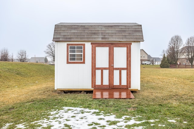 view of outbuilding featuring a lawn