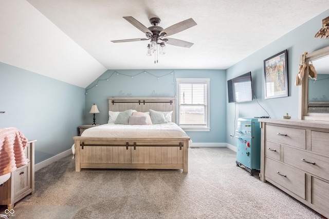 carpeted bedroom featuring lofted ceiling and ceiling fan