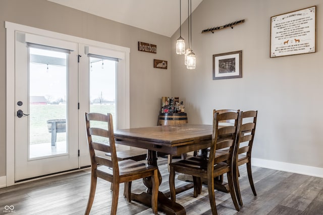 dining space with lofted ceiling and dark hardwood / wood-style floors