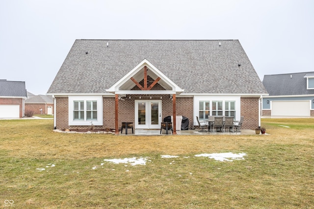 back of property featuring a lawn, a patio area, and french doors