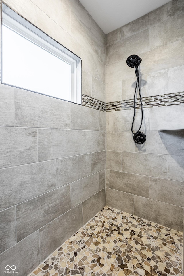 bathroom with a tile shower