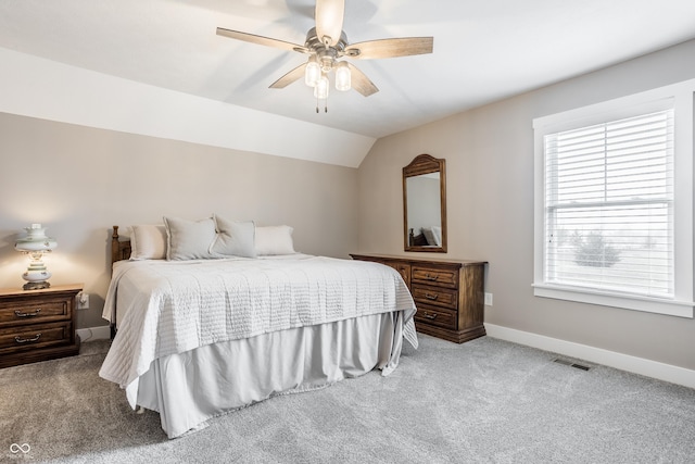 carpeted bedroom featuring lofted ceiling and ceiling fan