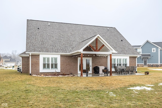 rear view of house featuring a yard and a patio area