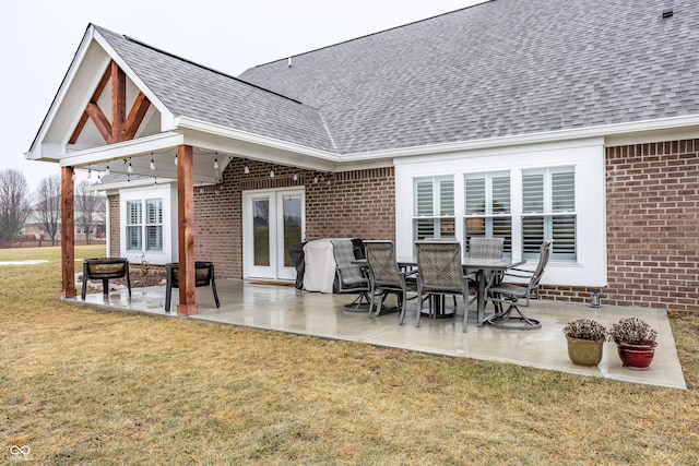 rear view of property featuring a yard and a patio