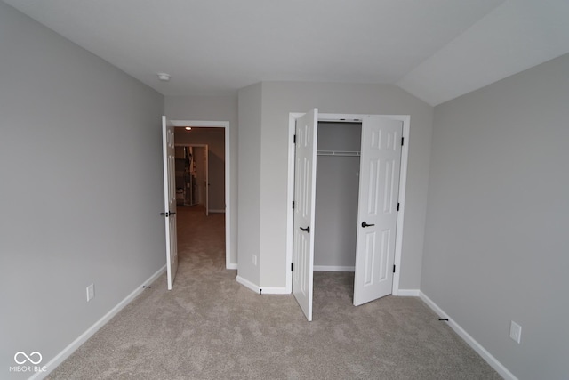 unfurnished bedroom with light carpet and a closet