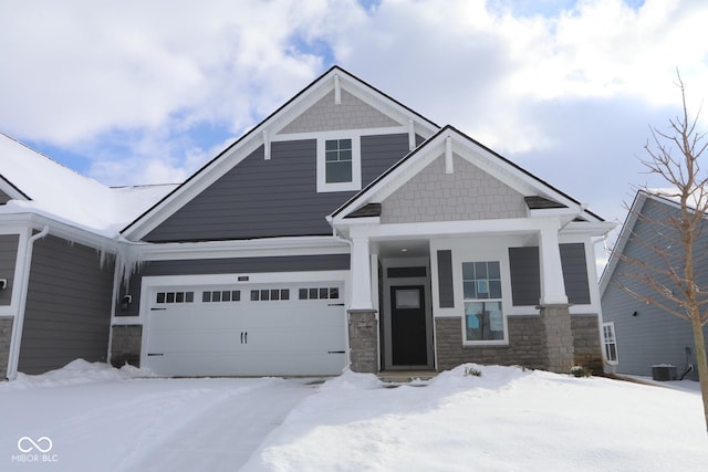 craftsman inspired home with a garage and central AC