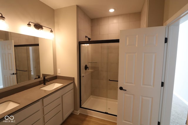 bathroom with walk in shower and vanity