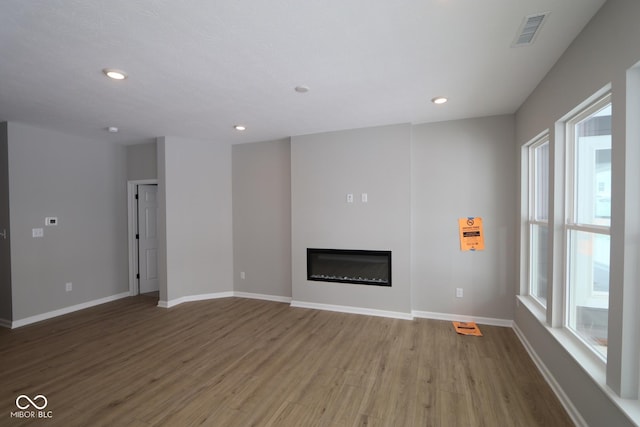 unfurnished living room featuring hardwood / wood-style flooring