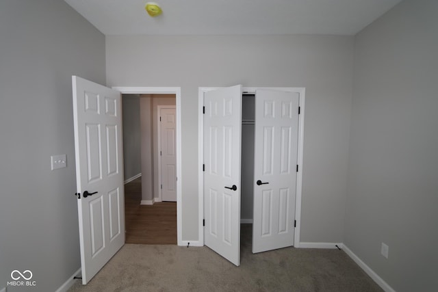 unfurnished bedroom featuring a closet and carpet flooring