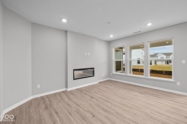 unfurnished living room with light wood-type flooring