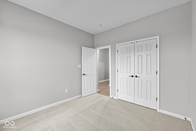 unfurnished bedroom featuring carpet and a closet