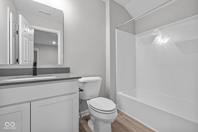 full bathroom with toilet, vanity, shower / tub combination, and wood-type flooring