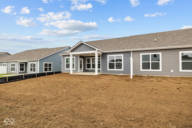 rear view of property featuring a patio and a yard