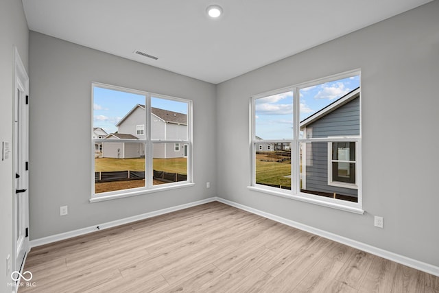 unfurnished room with light hardwood / wood-style floors