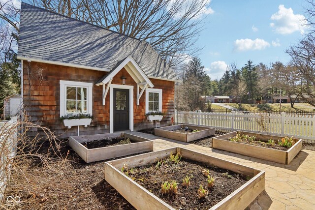 view of outbuilding with a garden and fence