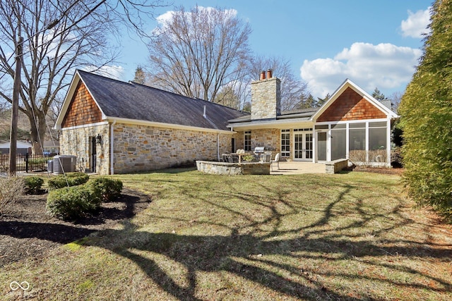 rear view of property featuring central AC unit, fence, a yard, a chimney, and french doors