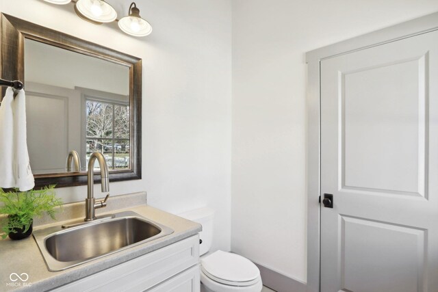 bathroom featuring toilet and vanity