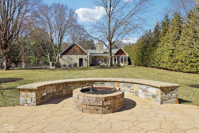 view of patio / terrace featuring a fire pit and fence