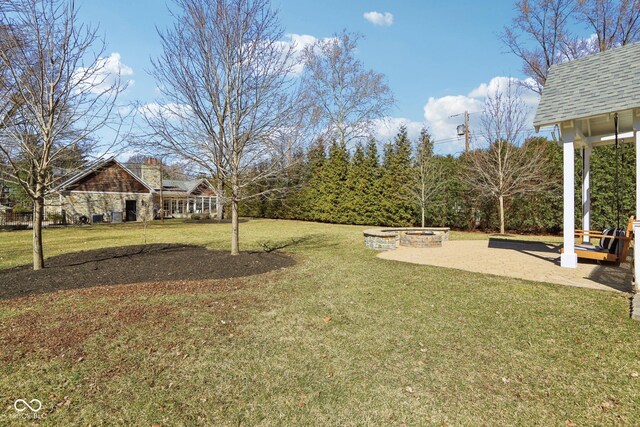 view of yard featuring a fire pit and a patio