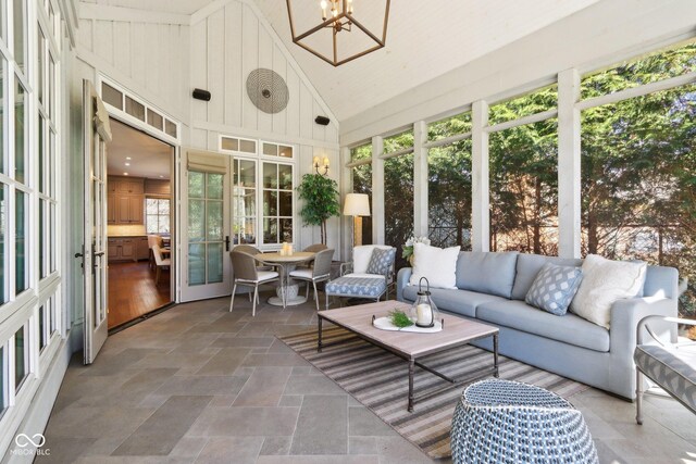 sunroom / solarium with a notable chandelier and vaulted ceiling