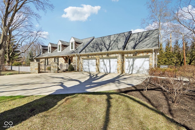 view of front of property featuring stone siding, concrete driveway, a garage, and fence