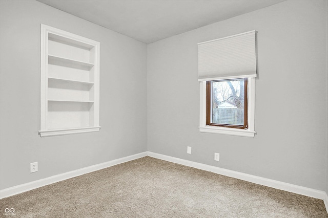 carpeted empty room with built in features