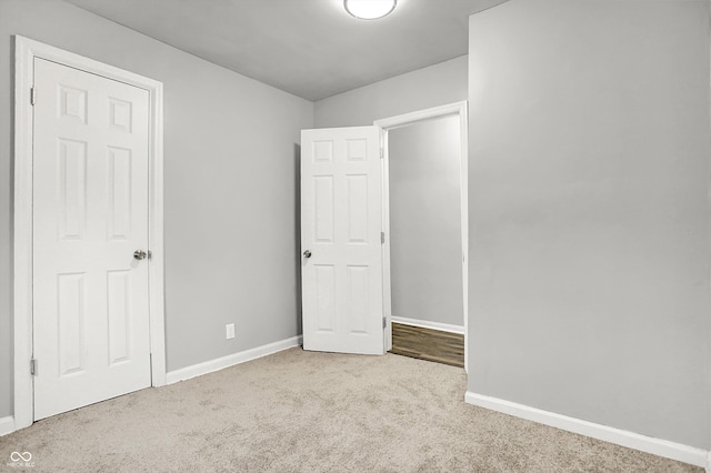 unfurnished bedroom featuring light colored carpet