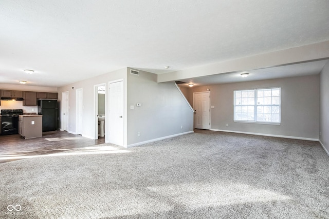 unfurnished living room featuring carpet flooring