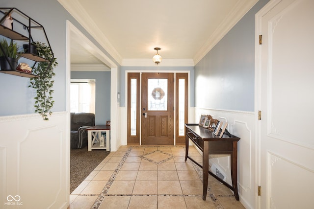 entrance foyer with crown molding and light tile patterned floors