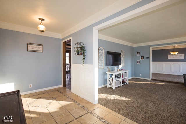 foyer entrance with ornamental molding and light tile patterned floors