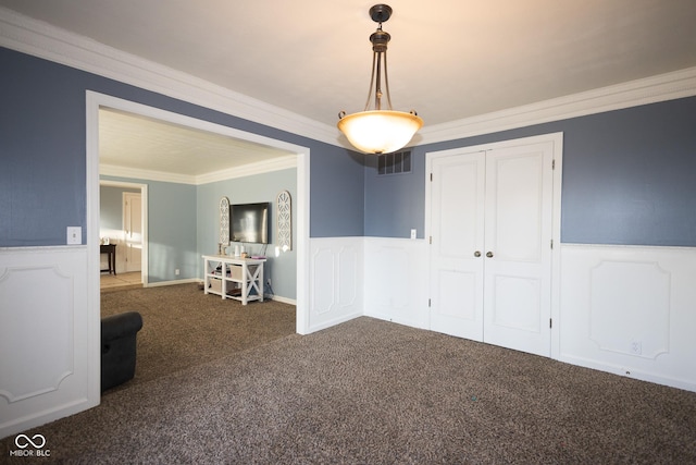 empty room with dark carpet and ornamental molding