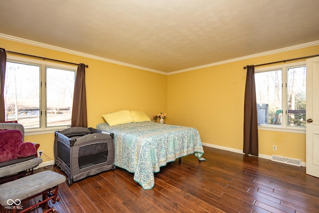 bedroom featuring crown molding and dark wood-type flooring