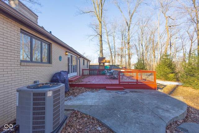 view of patio featuring cooling unit and a deck