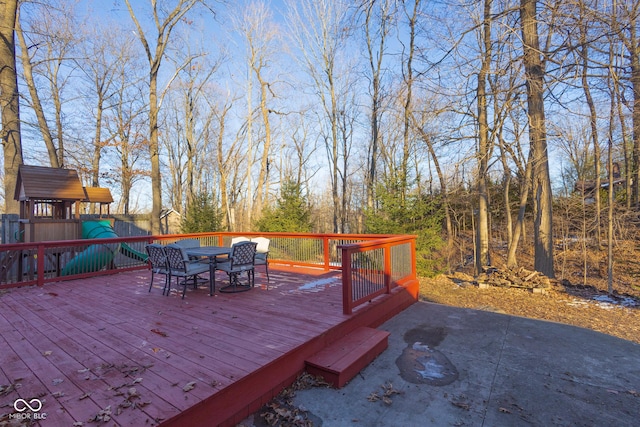 wooden deck featuring a playground