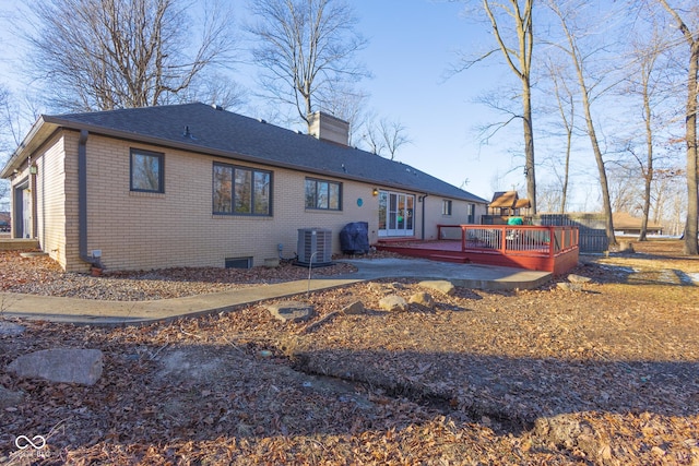 rear view of house with central AC and a deck