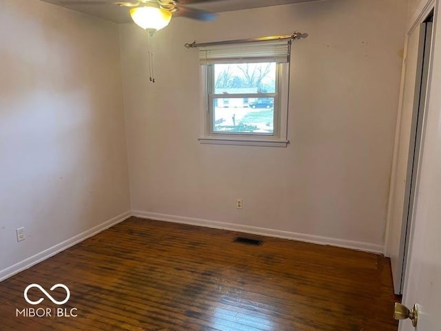 empty room featuring dark hardwood / wood-style floors and ceiling fan