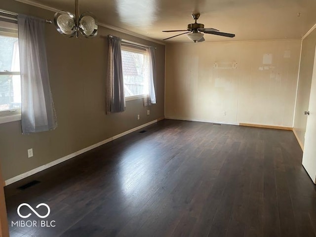 empty room with crown molding, dark wood-type flooring, and ceiling fan with notable chandelier