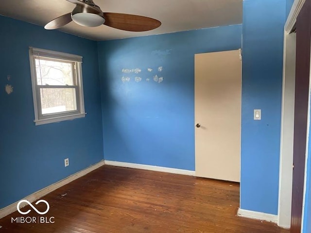 spare room featuring dark hardwood / wood-style flooring and ceiling fan