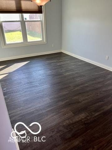 empty room with dark hardwood / wood-style flooring