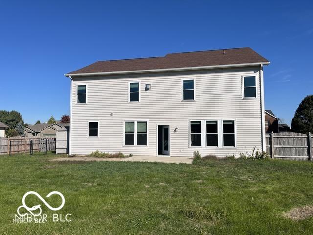 rear view of house with a yard