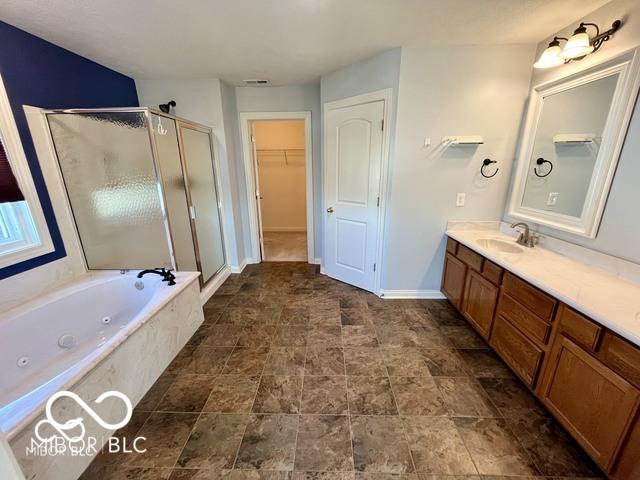 bathroom with shower with separate bathtub and vanity